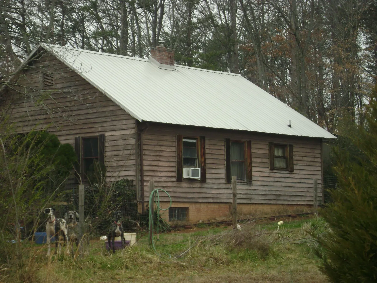 White metal roof on an old wood sided farmhouse, from a Metal Roof Installation job in Obion